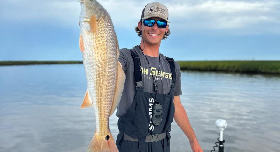 sabine trails guide service captain klate gohlke holding up a redfish on sabine lake in port arthur texas