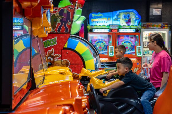 Max Bowl in Port Arthur TX kids riding a motorcyle arcade game