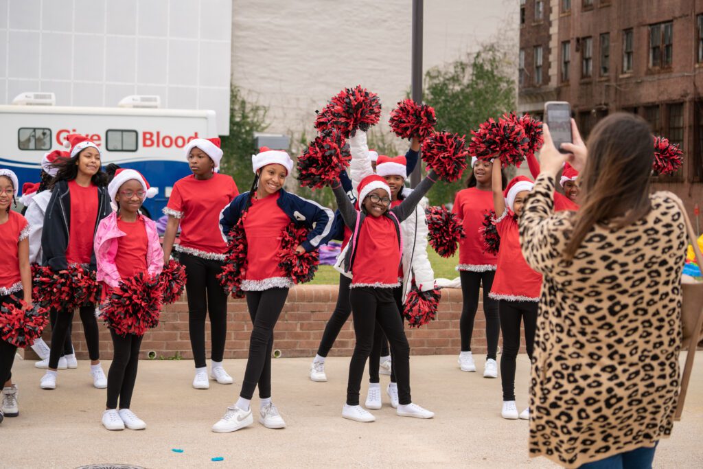 girls dancing with red pom poms at a christmas parade in downtown port arthur texas