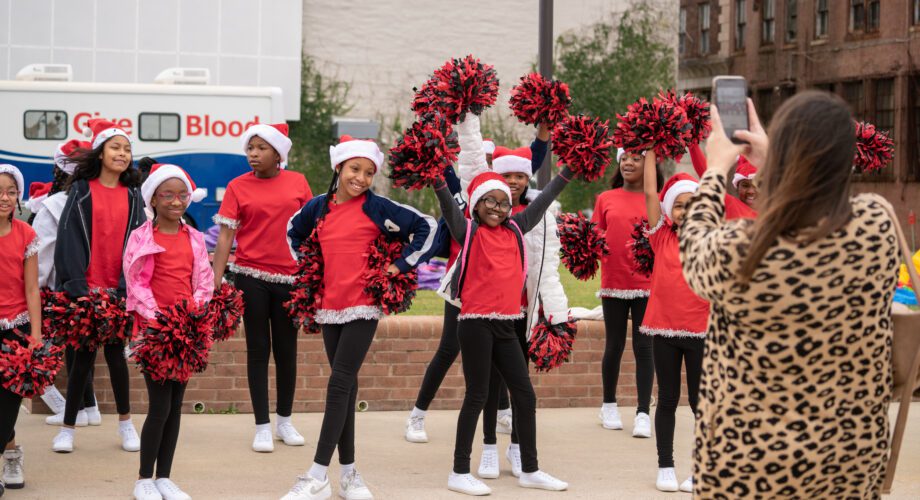 girls dancing with red pom poms at a christmas parade in downtown port arthur texas