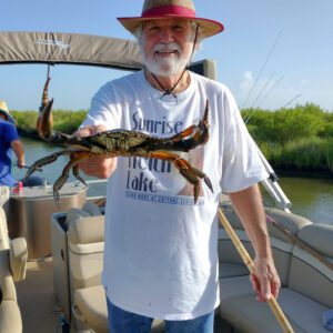 jim labove holding a crab at keith lake in port arthur texas