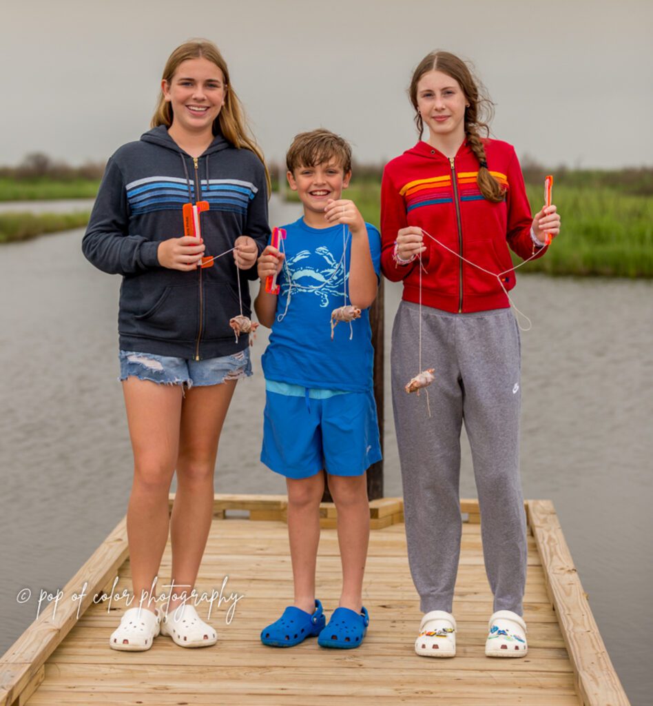 three kids holding their chicken before crabbing at sea rim state park in port arthur texas