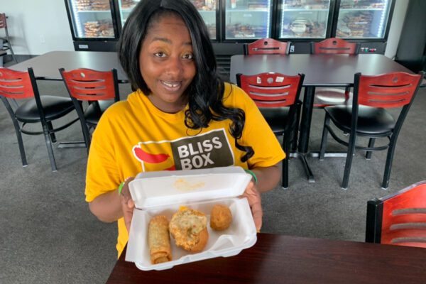 Bliss Box, woman holding foam box of Cajun food, Port Arthur , Texas