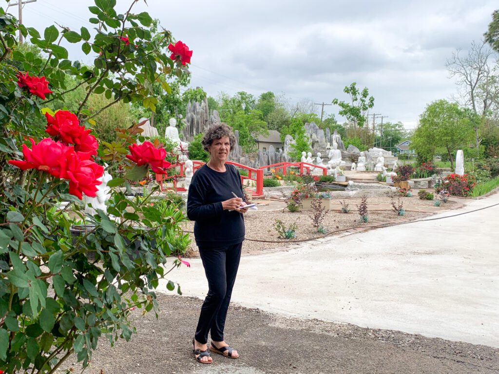 woman posing outside the buu mon buddhist temple in port arthur texas