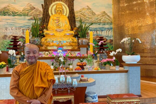monk standing inside buu mon buddhist temple in port arthur texas