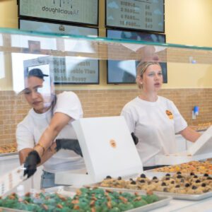 staff serving cookies at doughlicious in port arthur