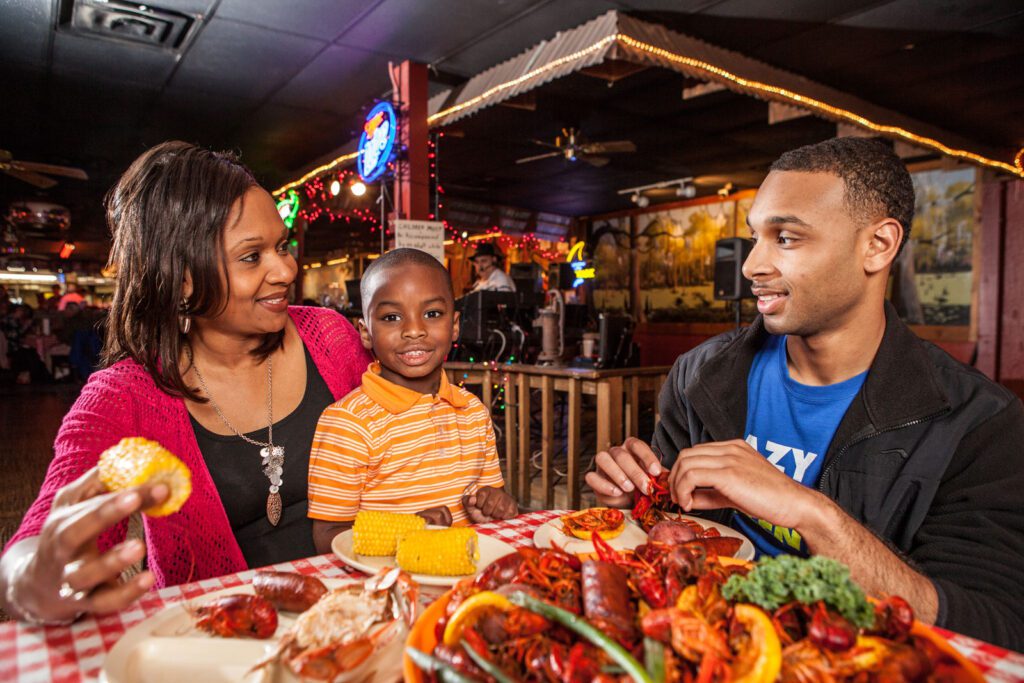 family of three eating crawfish at larry's in port arthur texas