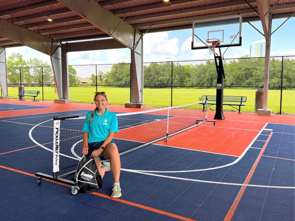girl kneeling on the pickleball courts at YMCA in Port Arthur Texas