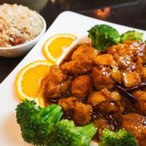 plate of orange chicken with broccoli