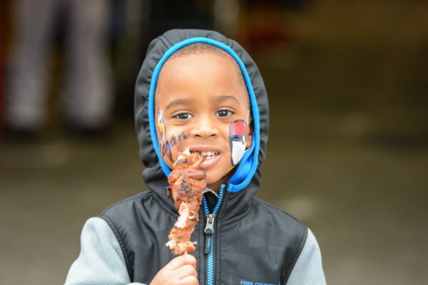 boy eating turkey leg at mardi gras port arthur