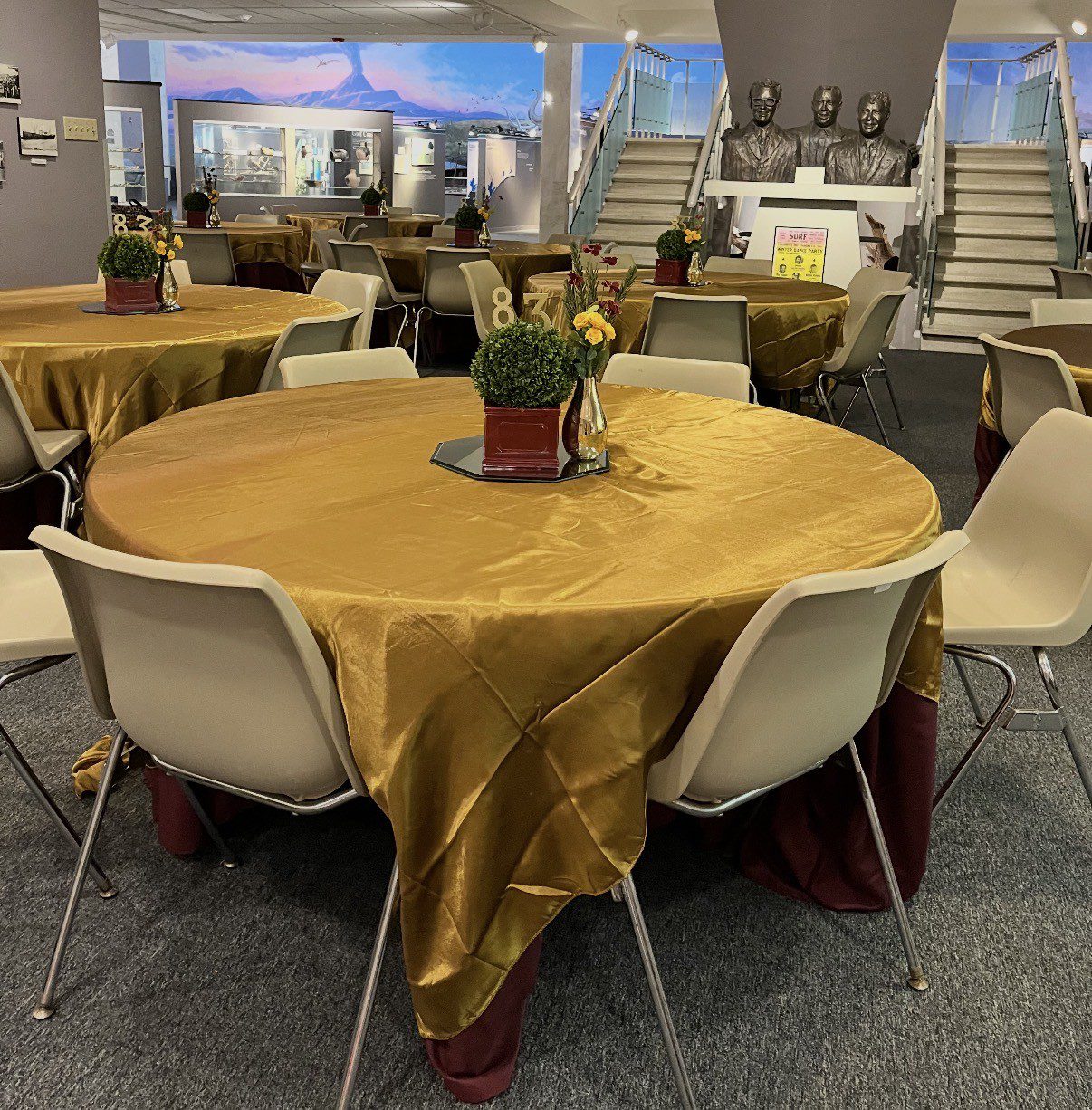 Museum of the Gulf Coast meeting space with gold tablecloths