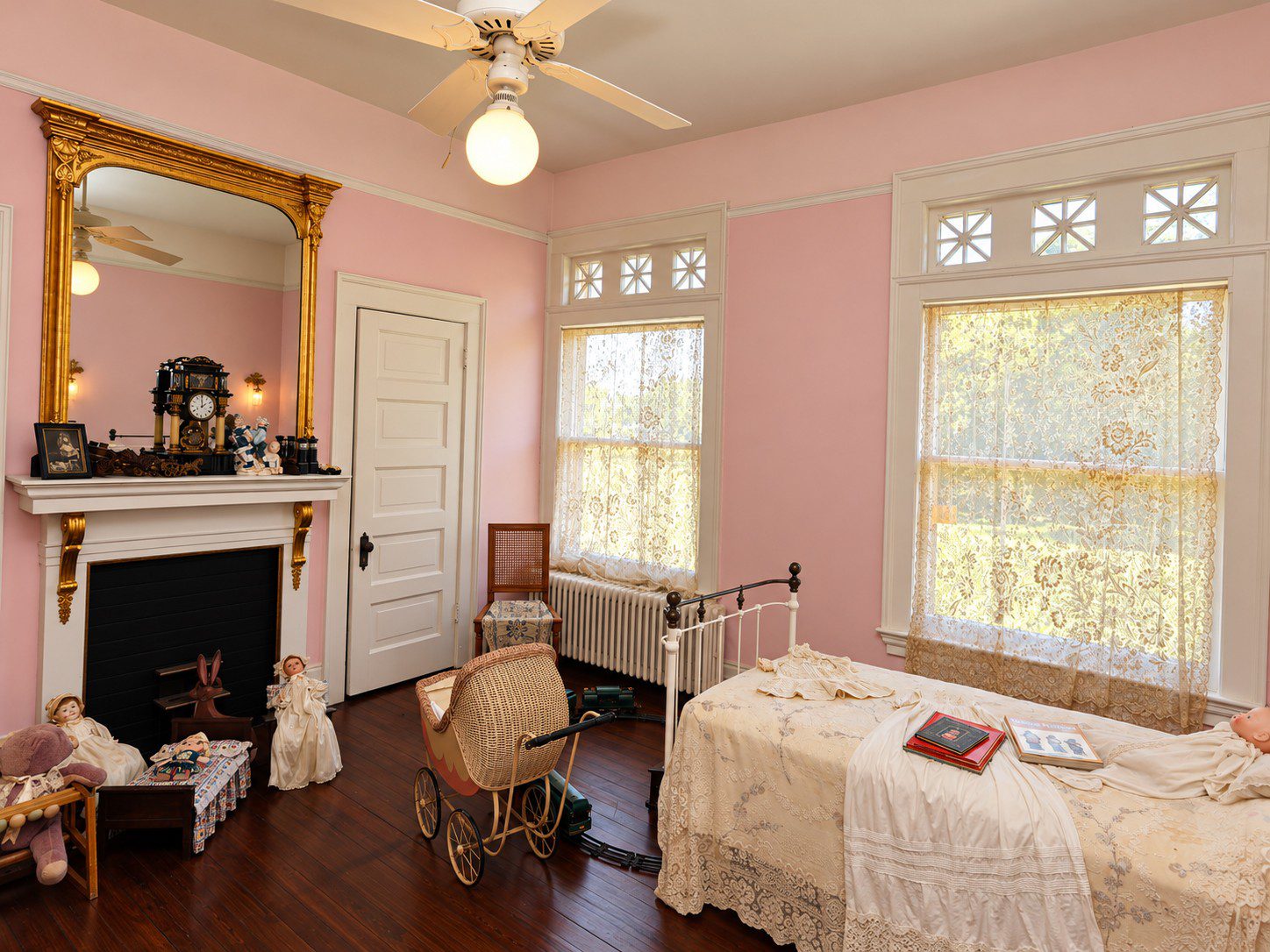 Pompeiian Villa carries the pink tones into an airy, lacy bedroom.